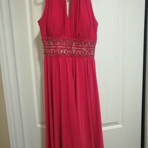 A hot pink, mid length halter top dress